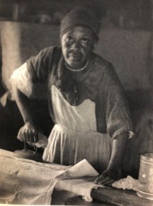 Artistic photo by Doris Ullmann of an African American woman ironing.